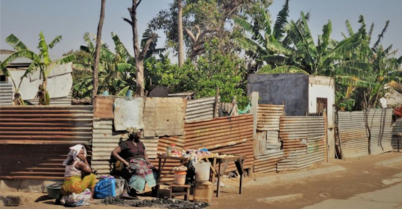Guinea Bissau. Women sitting in front of their houses